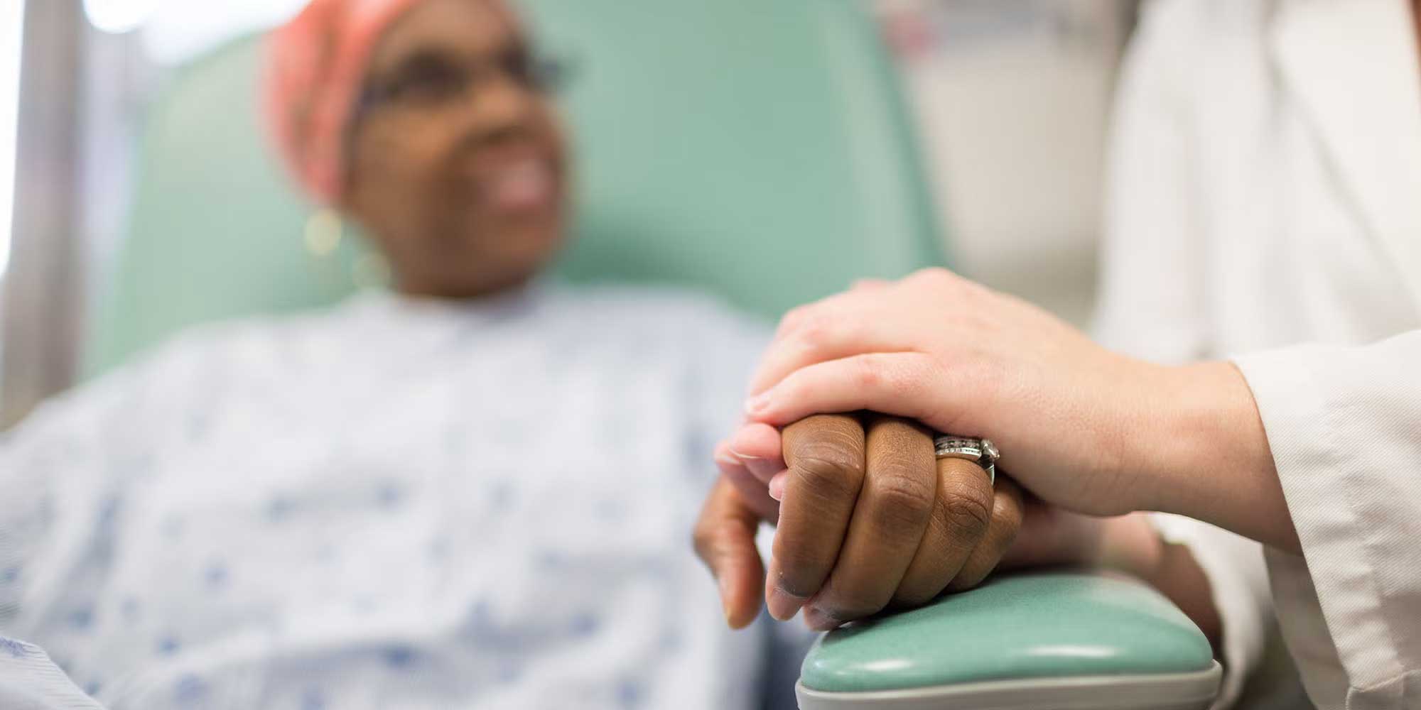 doctor holding patient's hand